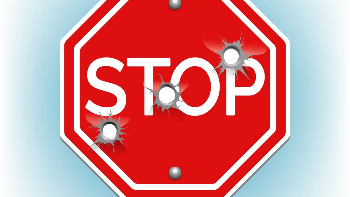Stop sign with bullet holes illustrates EU tech patents under fire.